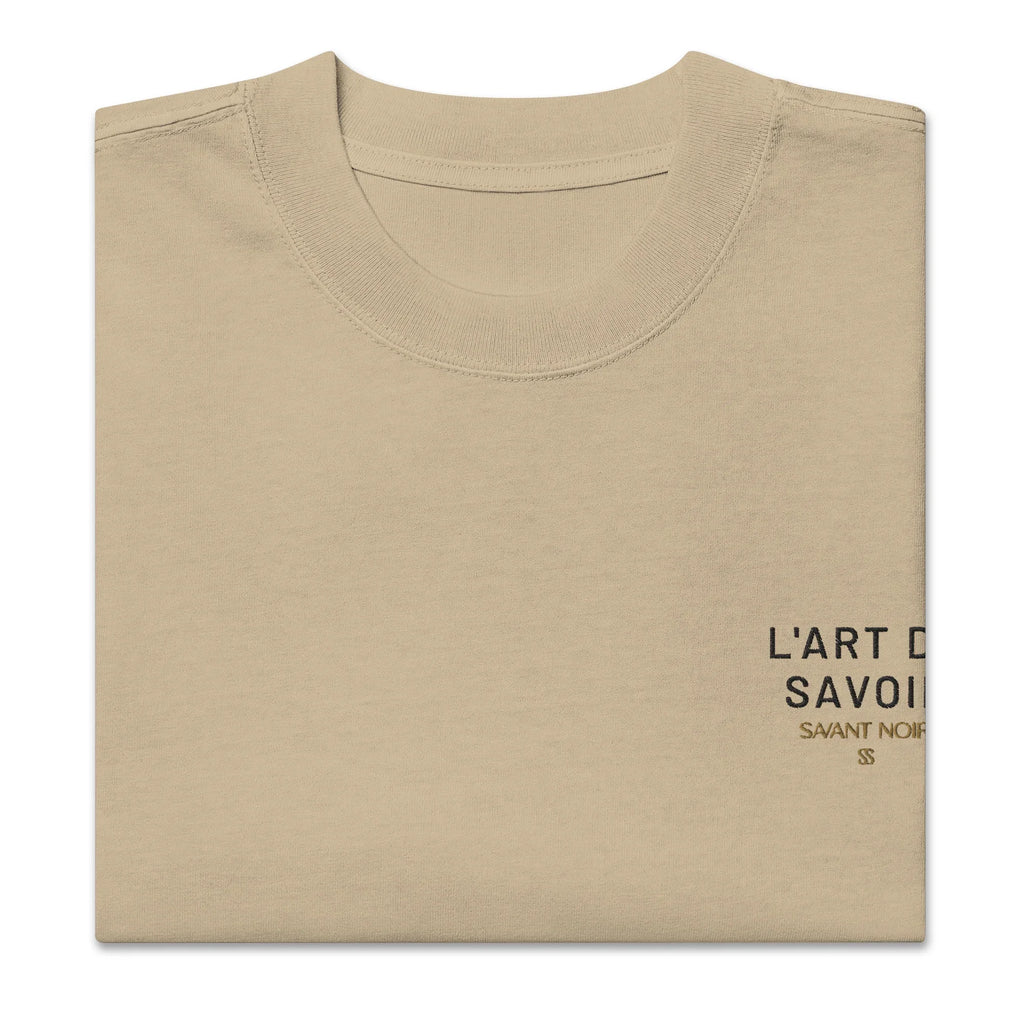 Beige luxury oversized streetwear tee by SAVANT NOIR with minimalist black text print on chest
