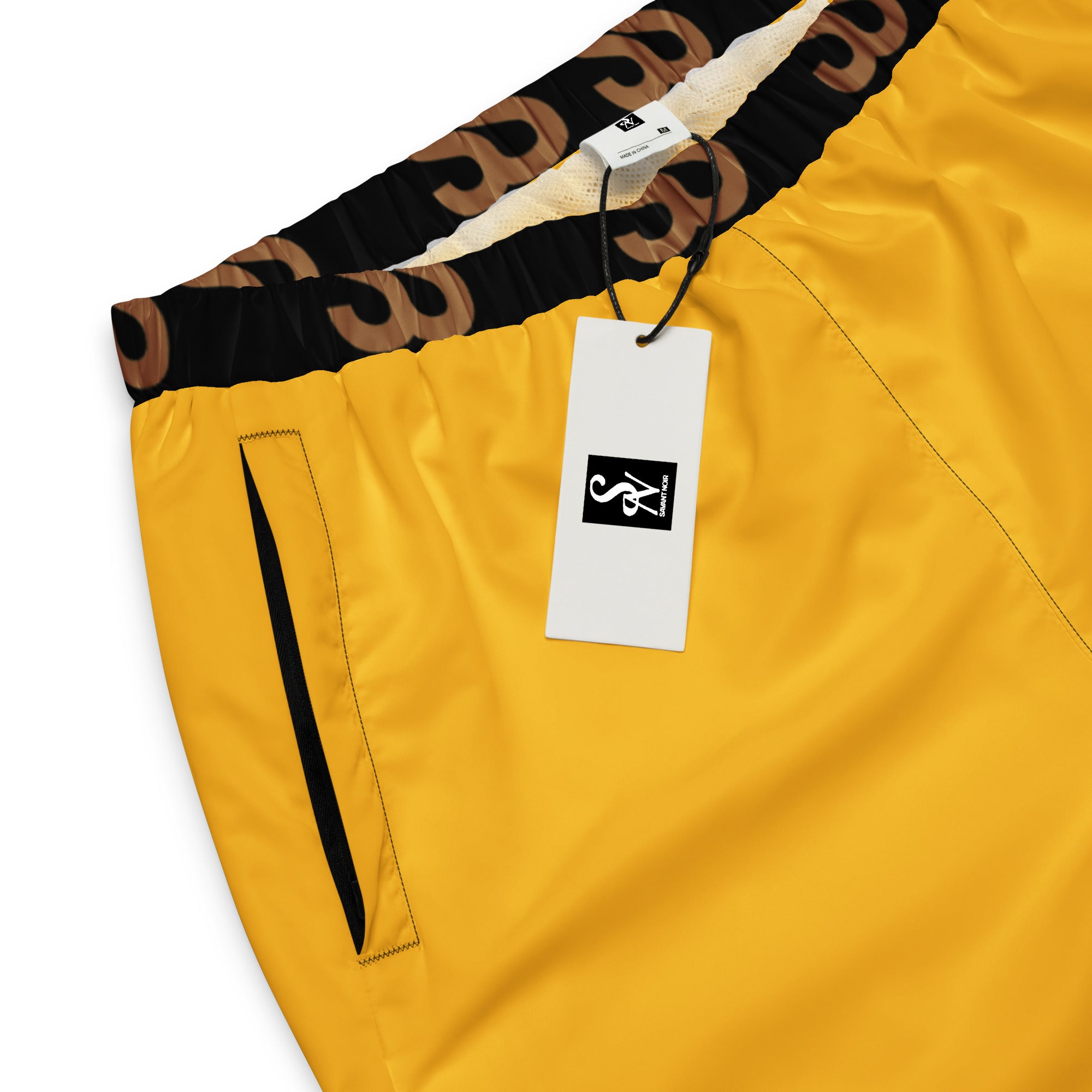 SAVANT NOIR high-end yellow track pants with black waistband and side pocket detail