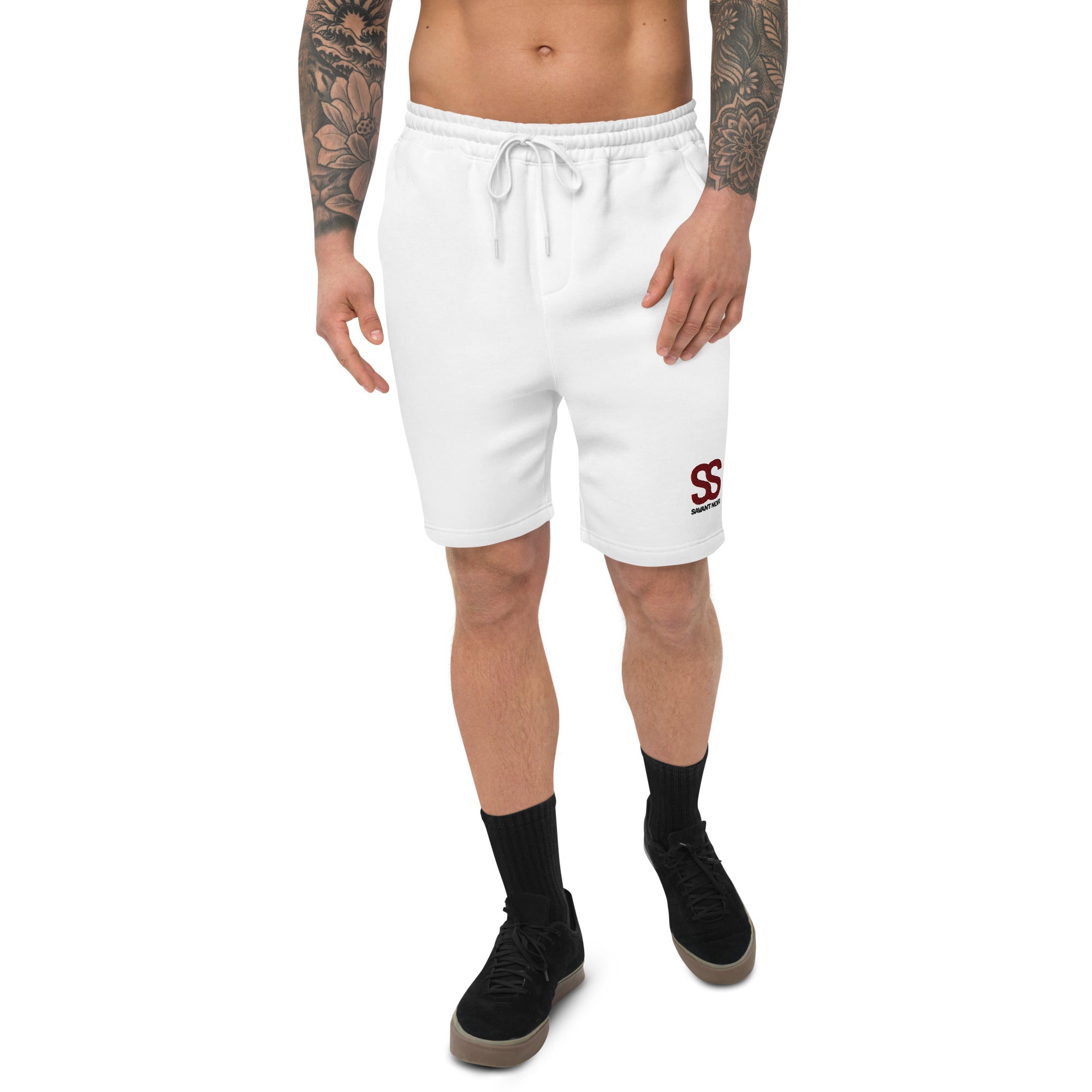 White luxury fleece shorts by SAVANT NOIR worn by tattooed male model with black sneakers