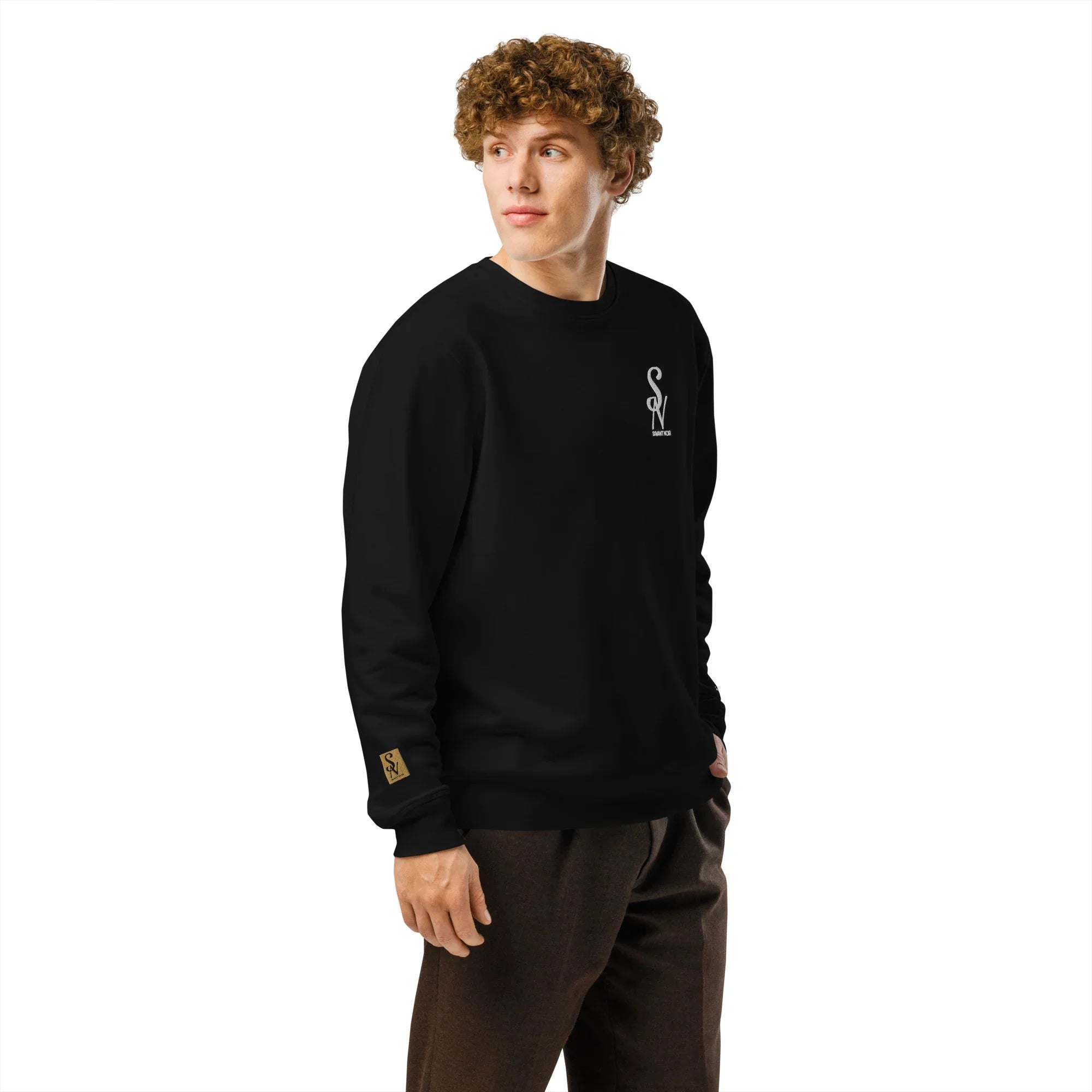 SAVANT NOIR luxury black crewneck sweatshirt worn by male model with curly hair and brown pants