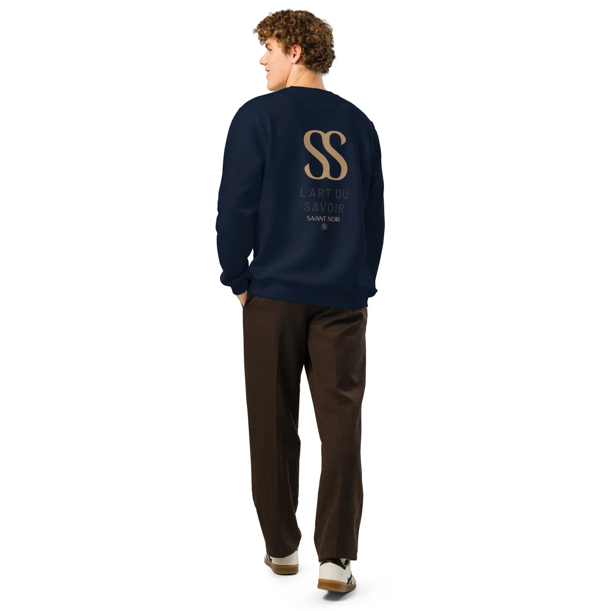 Back view of man wearing luxury black crewneck sweatshirt by SAVANT NOIR with gold logo print
