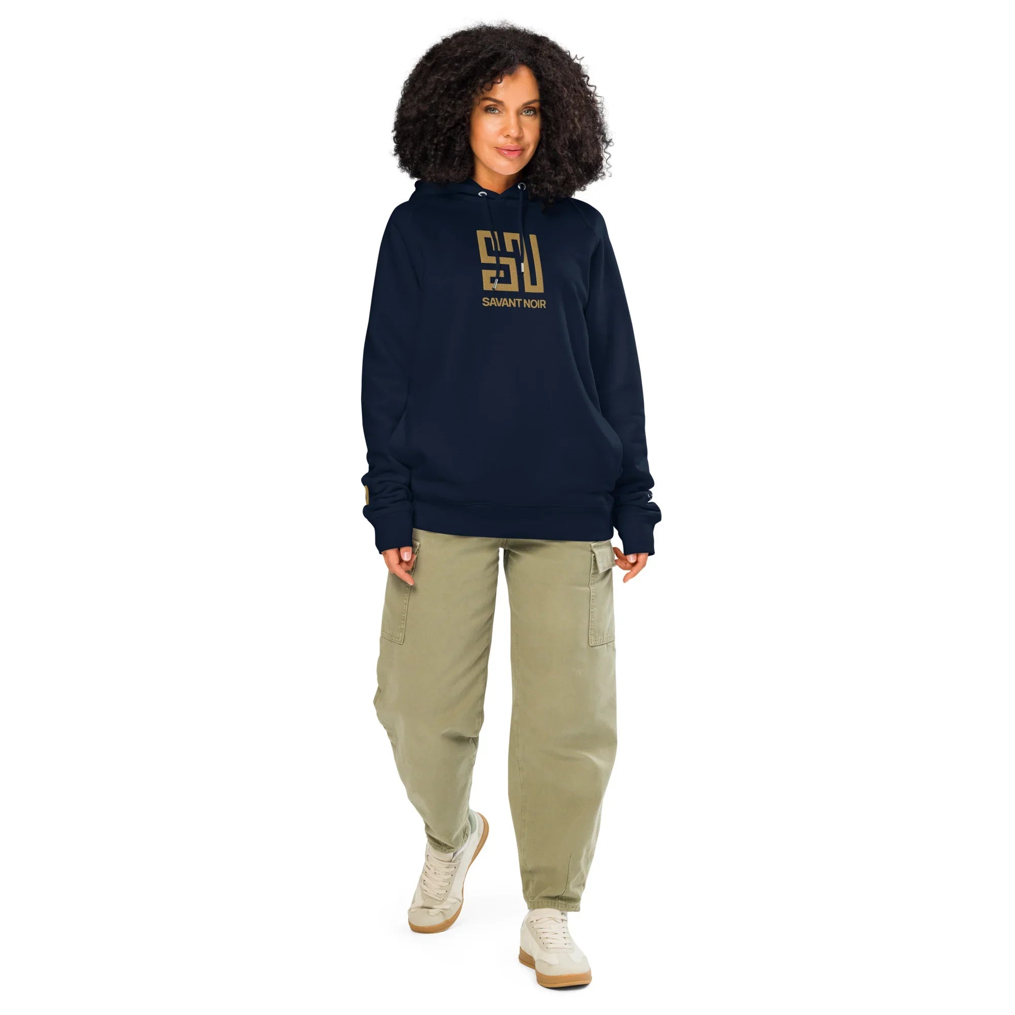 Luxury black gold embroidered hoodie by SAVANT NOIR worn by woman with beige pants and white sneakers