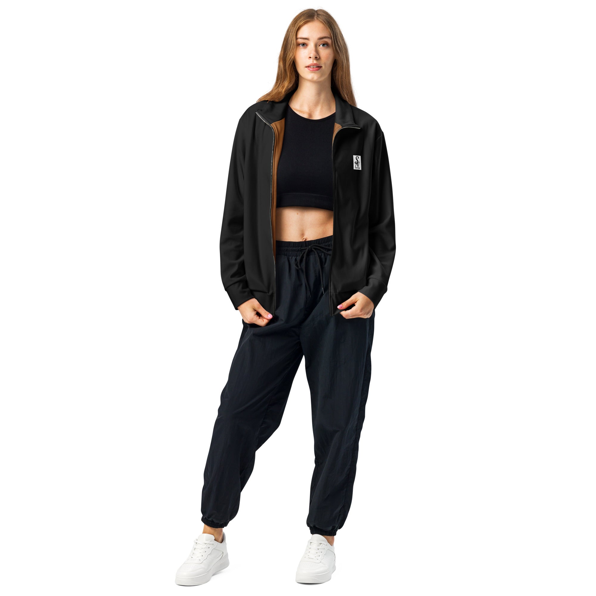Savant Noir luxury black track jacket worn by woman with black crop top and pants
