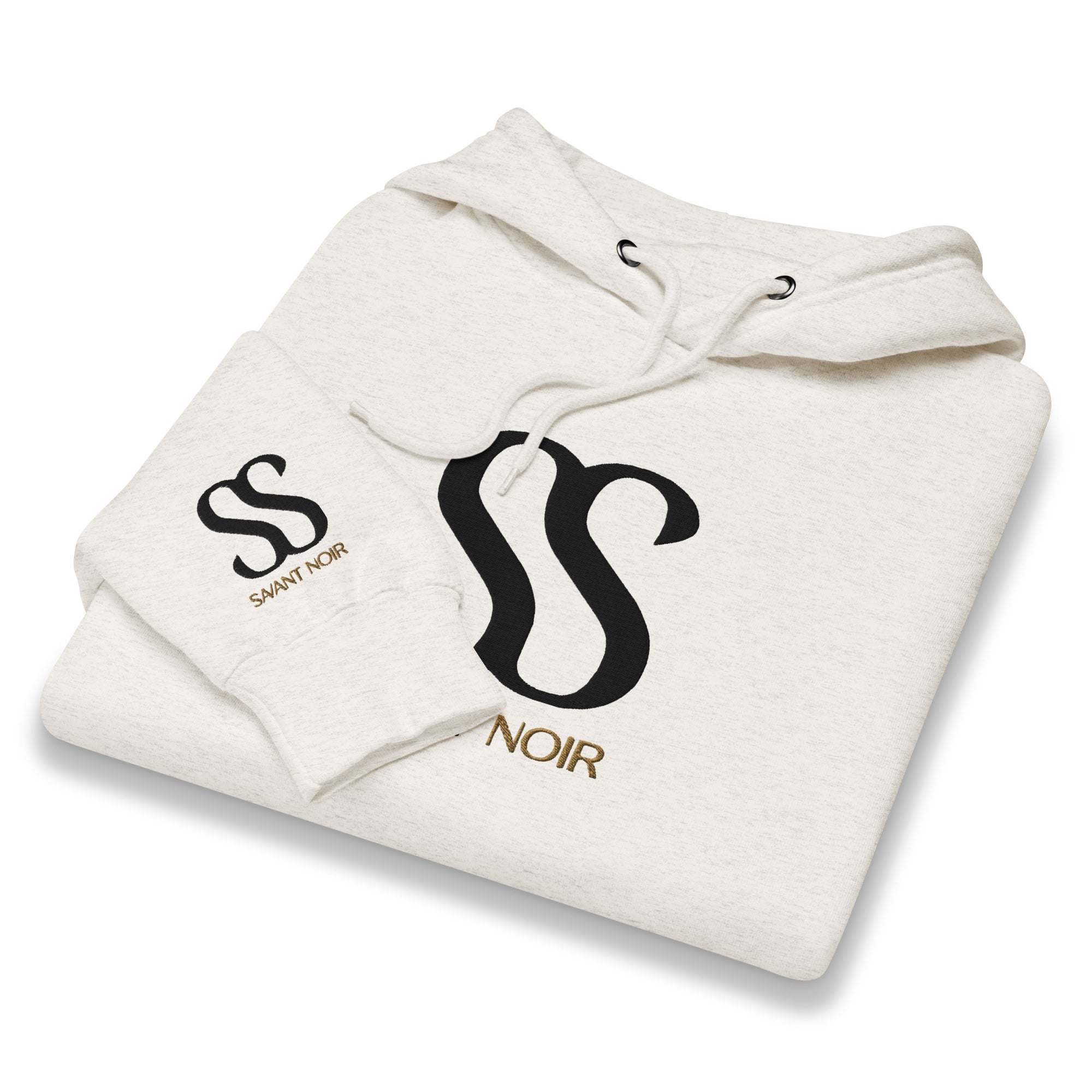 SAVANT NOIR luxury streetwear hoodie in light beige with black logo and gold text folded neatly