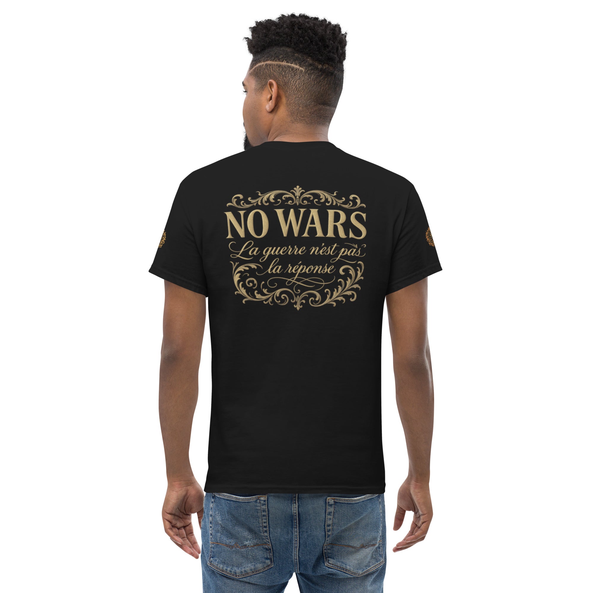 Back view of man wearing black NO WARS embroidered tee from SAVANT NOIR with gold decorative text