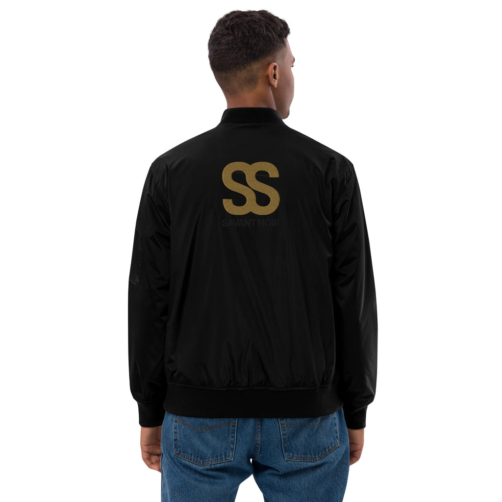 Back view of man wearing SAVANT NOIR designer olive bomber for men in black with logo detail