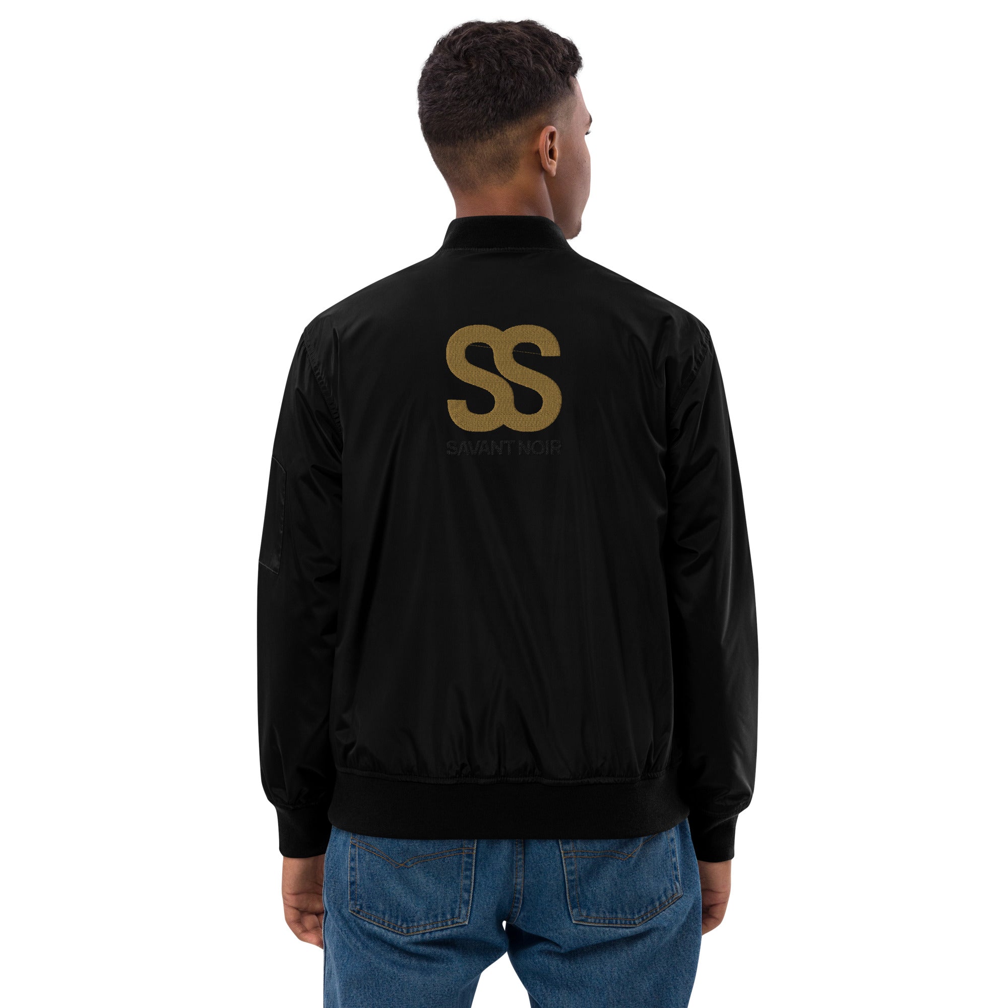 Back view of man wearing SAVANT NOIR designer olive bomber for men in black with logo detail