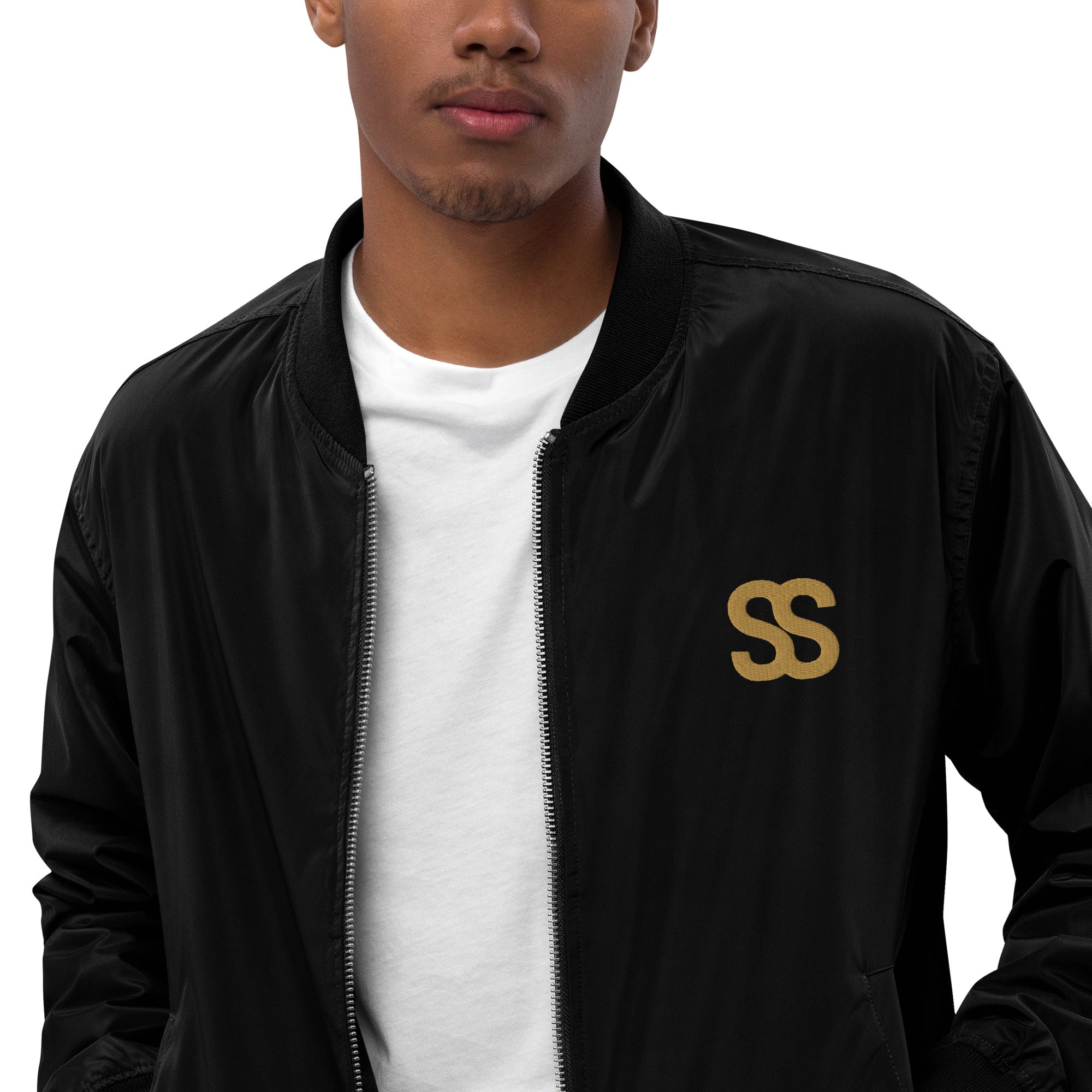 SAVANT NOIR black bomber jacket with SS logo worn over white shirt, designer olive bomber for men style