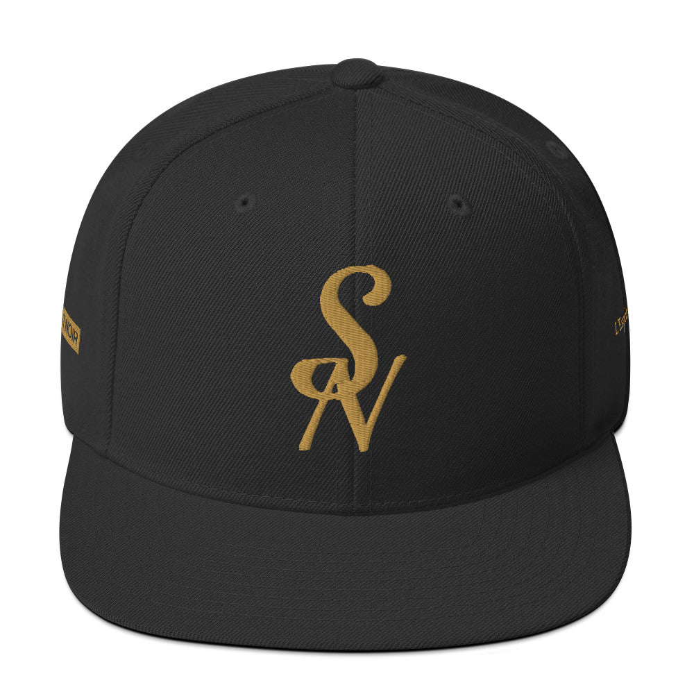 Black SAVANT NOIR luxury snapback hat with gold embroidered SN logo on front