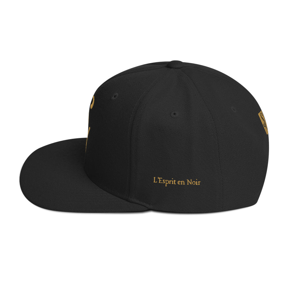 SAVANT NOIR black luxury snapback hat with gold embroidered text L'Esprit en Noir on side